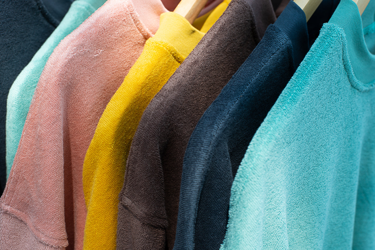 Five colours of towelling sweatshirts - from left to right: Oil Blue, Old Rose, sunflower, Soft Brown, India Ink